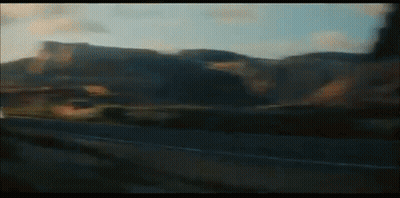 A Blurry Picture Of A Car Driving Down A Road GIF