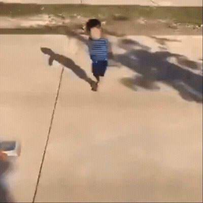 A Blurry Picture Of A Child Walking Down A Street GIF