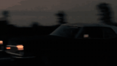 A Blurry Picture Of A City Skyline At Sunset With The Twin Towers Visible GIF