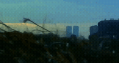 A Blurry Picture Of A City Skyline With A Few Buildings In The Background GIF