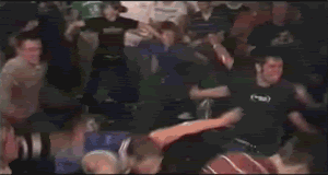 A Blurry Picture Of A Crowd Of People Dancing In A Dark Room GIF