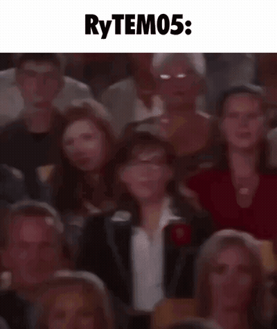 A Blurry Picture Of A Crowd Of People Sitting In A Theater With The Words Rytem05 Written Above Them . GIF