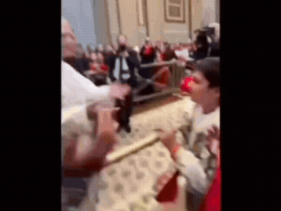 A Blurry Picture Of A Crowd Of People Standing In A Church . GIF