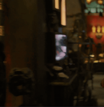 A Blurry Picture Of A Dark Room With A Few Lights Visible GIF