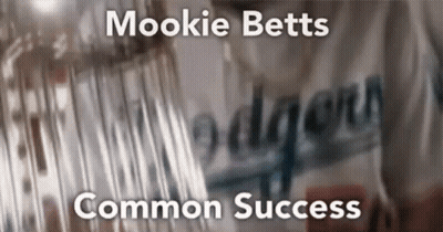 A Blurry Picture Of A Dodgers Jersey With The Words Mookie Betts Common Success GIF