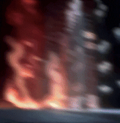 A Blurry Picture Of A Fire Coming Out Of A Building . GIF