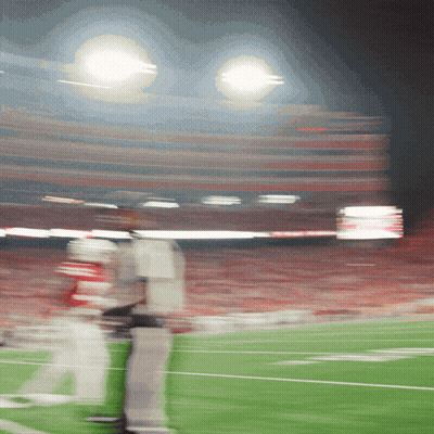 A Blurry Picture Of A Football Field With A Few Players GIF