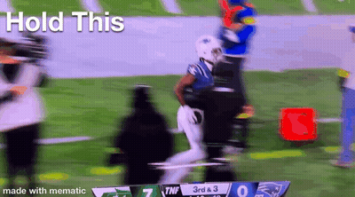 A Blurry Picture Of A Football Game With The Words Hold This In The Corner . GIF