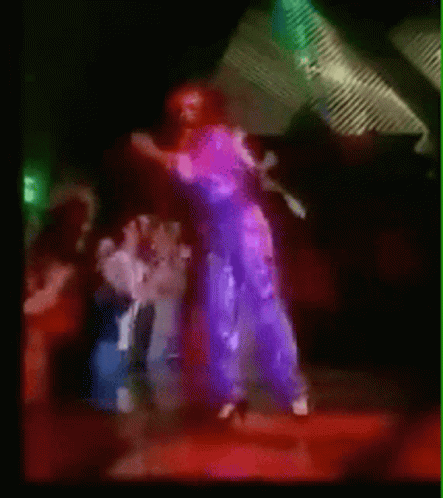 A Blurry Picture Of A Group Of People Dancing In A Club GIF