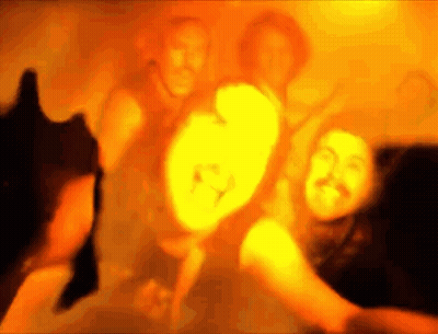 A Blurry Picture Of A Group Of People Dancing In A Dark Room . GIF