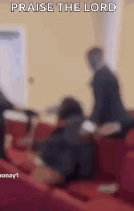 A Blurry Picture Of A Group Of People Sitting In A Church With The Words Praise The Lord . GIF
