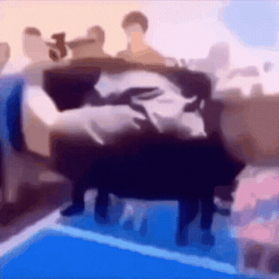 A Blurry Picture Of A Group Of People Sitting On A Bed GIF