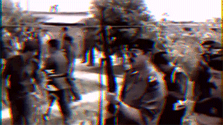 A Blurry Picture Of A Group Of People Standing Around GIF