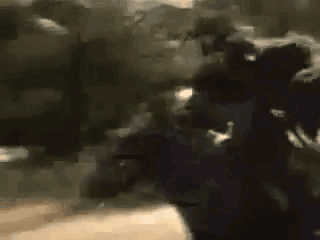 A Blurry Picture Of A Group Of People Standing In A Crowd . GIF