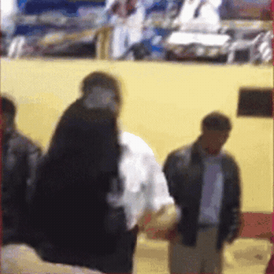 A Blurry Picture Of A Group Of People Standing In Front Of A Wall GIF