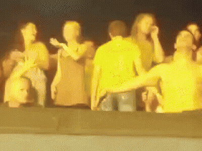A Blurry Picture Of A Group Of People Standing Together GIF