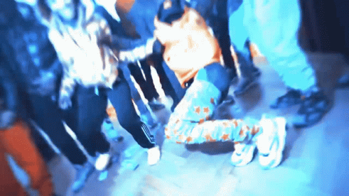 A Blurry Picture Of A Group Of People With One Wearing A Shirt That Says ' Adidas ' GIF