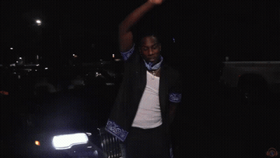A Blurry Picture Of A Group Of People With The Letter M In The Middle GIF