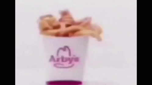A Blurry Picture Of A Hamburger On A White Surface . GIF