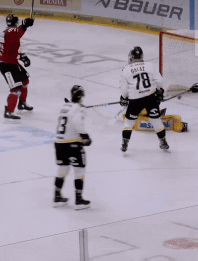 A Blurry Picture Of A Hockey Player In A Red Uniform GIF