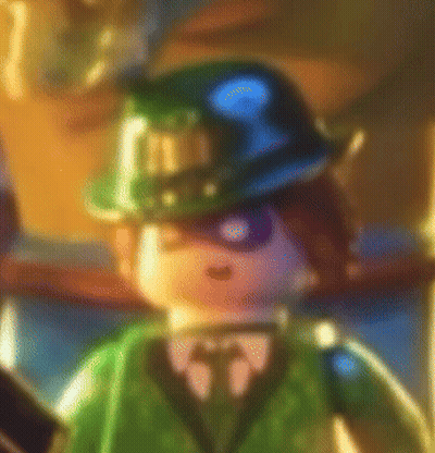 A Blurry Picture Of A Lego Batman Character Wearing A Hat And Tie . GIF