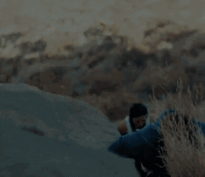 A Blurry Picture Of A Man And A Woman Hiking Up A Hill GIF