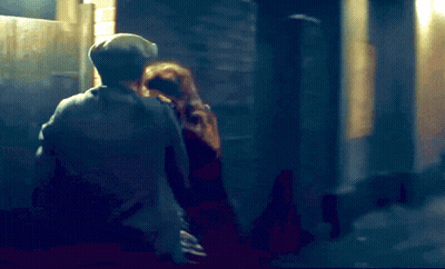 A Blurry Picture Of A Man And A Woman In A Dark Alleyway GIF