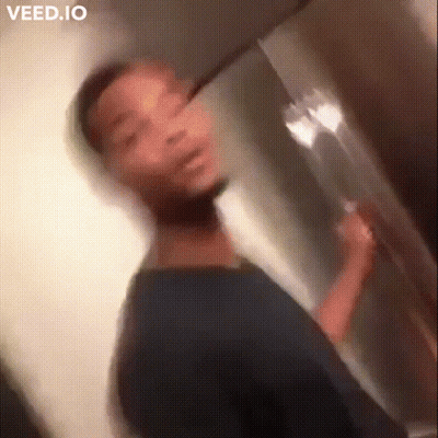 A Blurry Picture Of A Man Brushing His Teeth In A Bathroom GIF