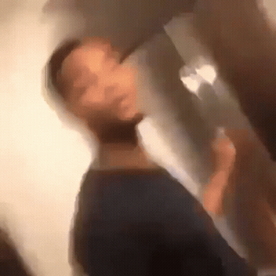 A Blurry Picture Of A Man Drinking From A Glass GIF