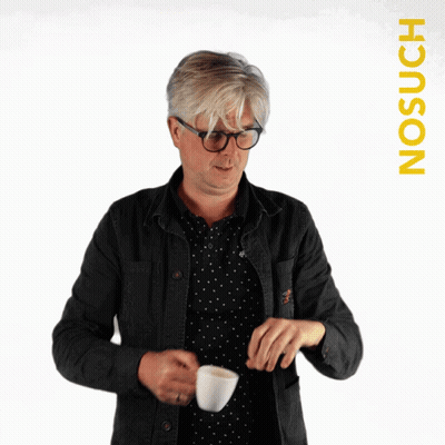 A Blurry Picture Of A Man Holding A Cup With The Word Nosuch On The Bottom GIF