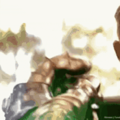 A Blurry Picture Of A Man Holding A Green Bottle GIF