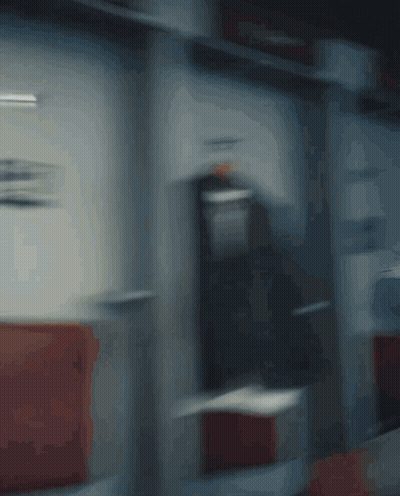 A Blurry Picture Of A Man Holding A Red Fire Extinguisher GIF