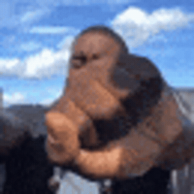 A Blurry Picture Of A Man Holding His Fist Up In The Air . GIF