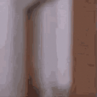 A Blurry Picture Of A Man In A Bathrobe Standing In A Room . GIF