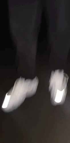 A Blurry Picture Of A Man In A Black Jacket Holding A Gun . GIF