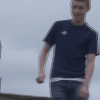 A Blurry Picture Of A Man In A Blue Adidas Shirt GIF