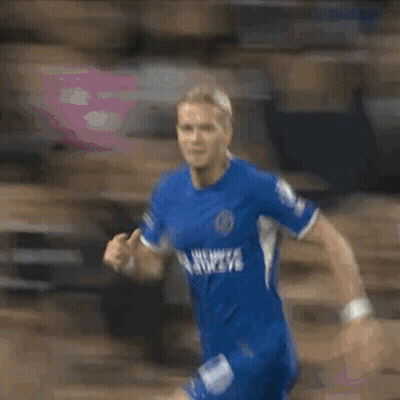 A Blurry Picture Of A Man In A Blue Jersey GIF