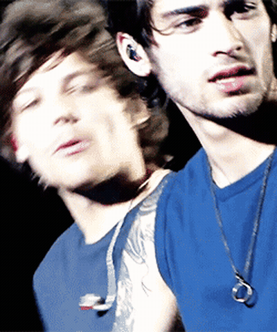 A Blurry Picture Of A Man In A Blue Shirt GIF