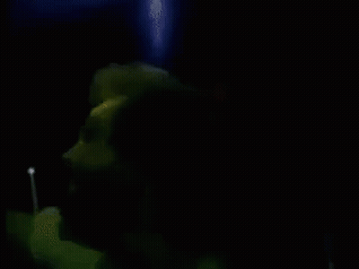 A Blurry Picture Of A Man In A Dark Room GIF