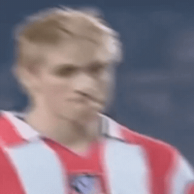 A Blurry Picture Of A Man In A Red And White Striped Shirt . GIF