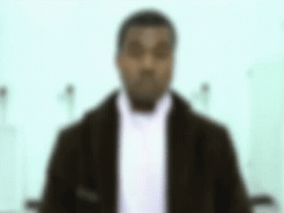 A Blurry Picture Of A Man In A Suit And Scarf . GIF