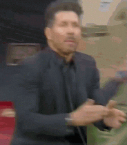 A Blurry Picture Of A Man In A Suit Dancing GIF