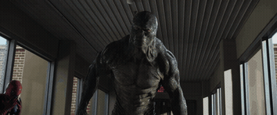 A Blurry Picture Of A Man In A Superhero Costume Fighting Another Man GIF