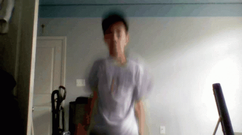 A Blurry Picture Of A Man In A White Shirt With The Word Abercrombie On The Front GIF
