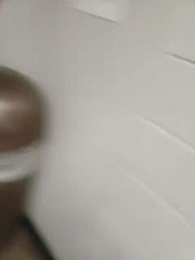 A Blurry Picture Of A Man In A Yellow Jacket Taking A Picture Of Himself In A Mirror GIF