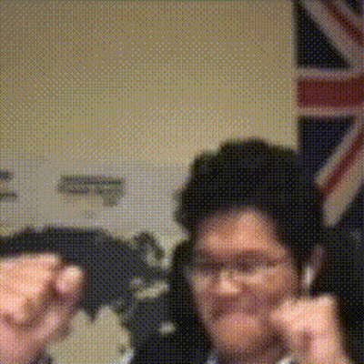 A Blurry Picture Of A Man In Front Of A Flag GIF