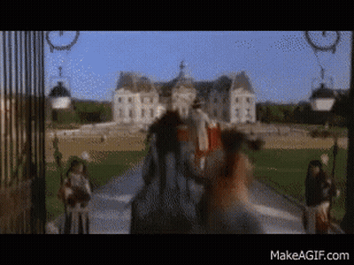 A Blurry Picture Of A Man Riding A Horse In Front Of A Castle With The Website Makeagif.com Visible GIF