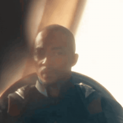 A Blurry Picture Of A Man 'S Face In A Dark Room . GIF