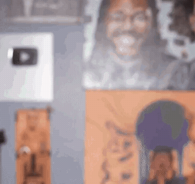 A Blurry Picture Of A Man 'S Face Is Hanging On A Wall Next To A Painting Of A Cat . GIF