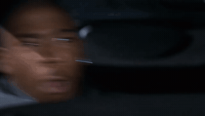 A Blurry Picture Of A Man 'S Face Looking Out A Car Window . GIF